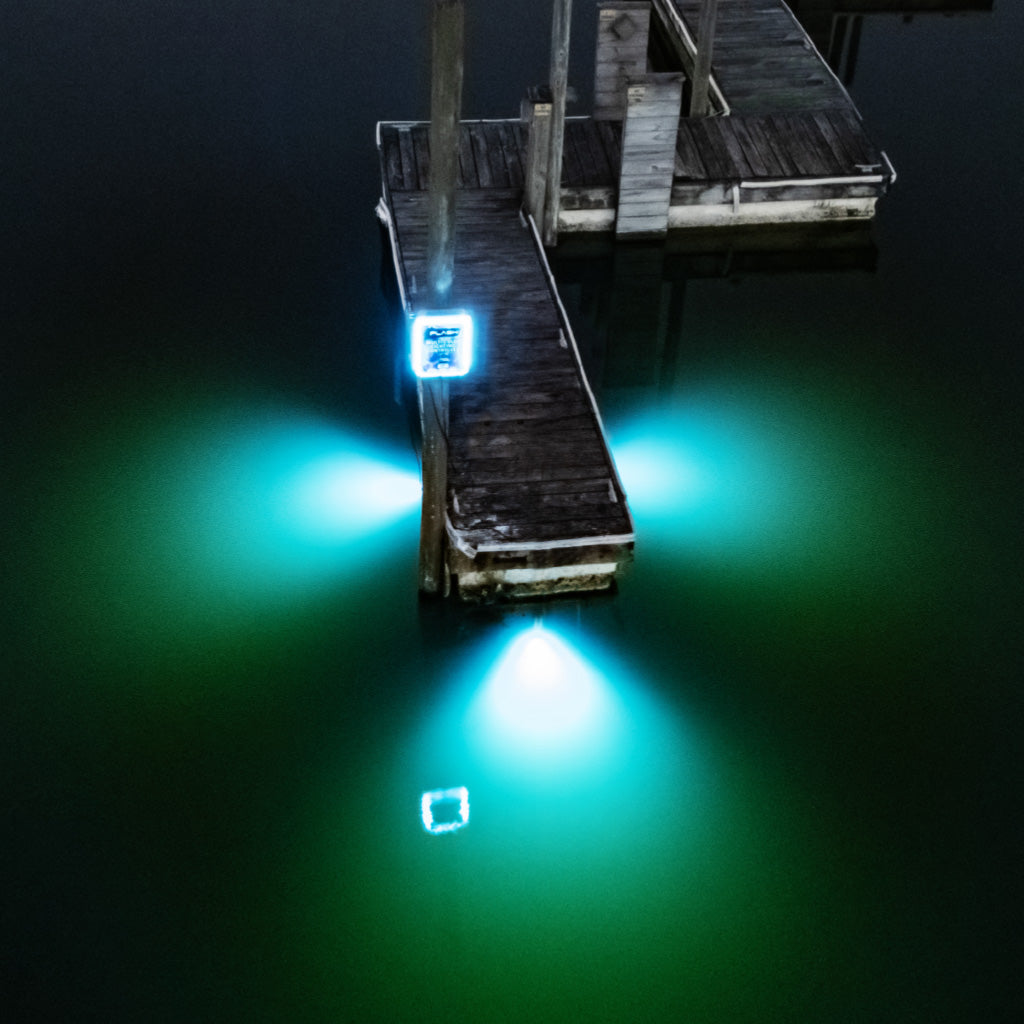 Wooden dock with glowing green LED lights in a dark water setting
