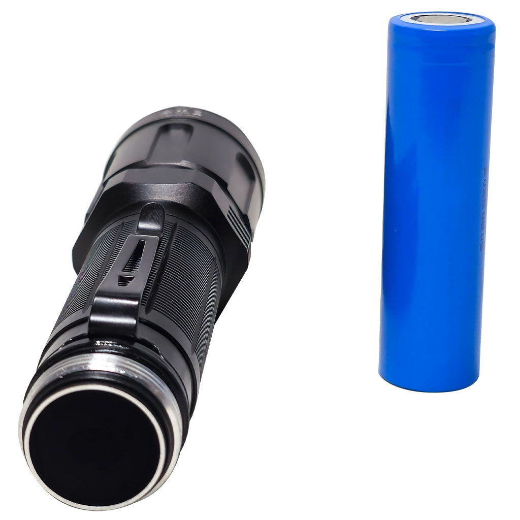 Black LED flashlight and blue battery on a white background