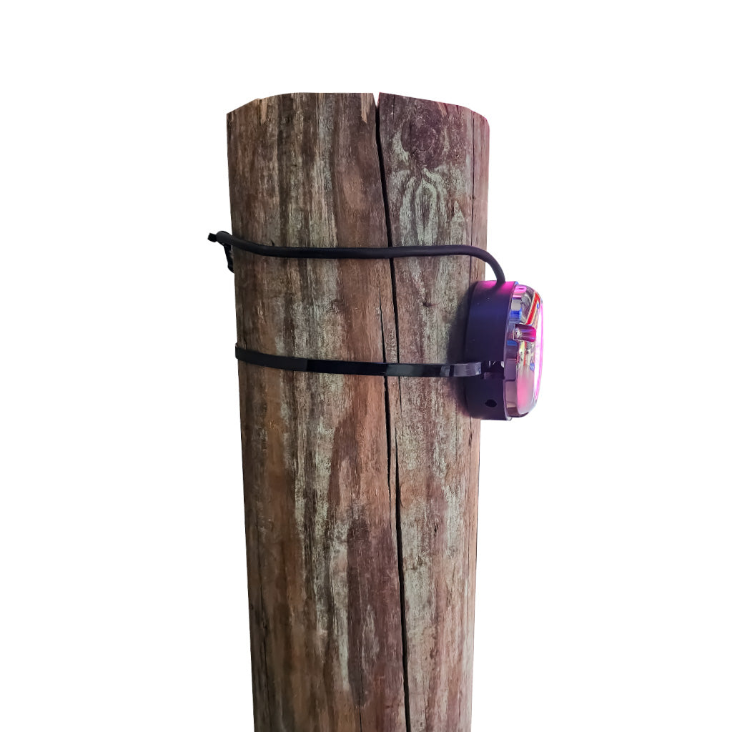 Plash branded Epik underwater LED light installed on dock pylon with black spacer and attached with large zip tie. On white background.