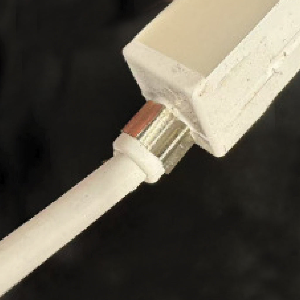 A close up of a Plash Mega Neon flexible light strip.  Showing a close up of the rear exiting power cable, on black background.
