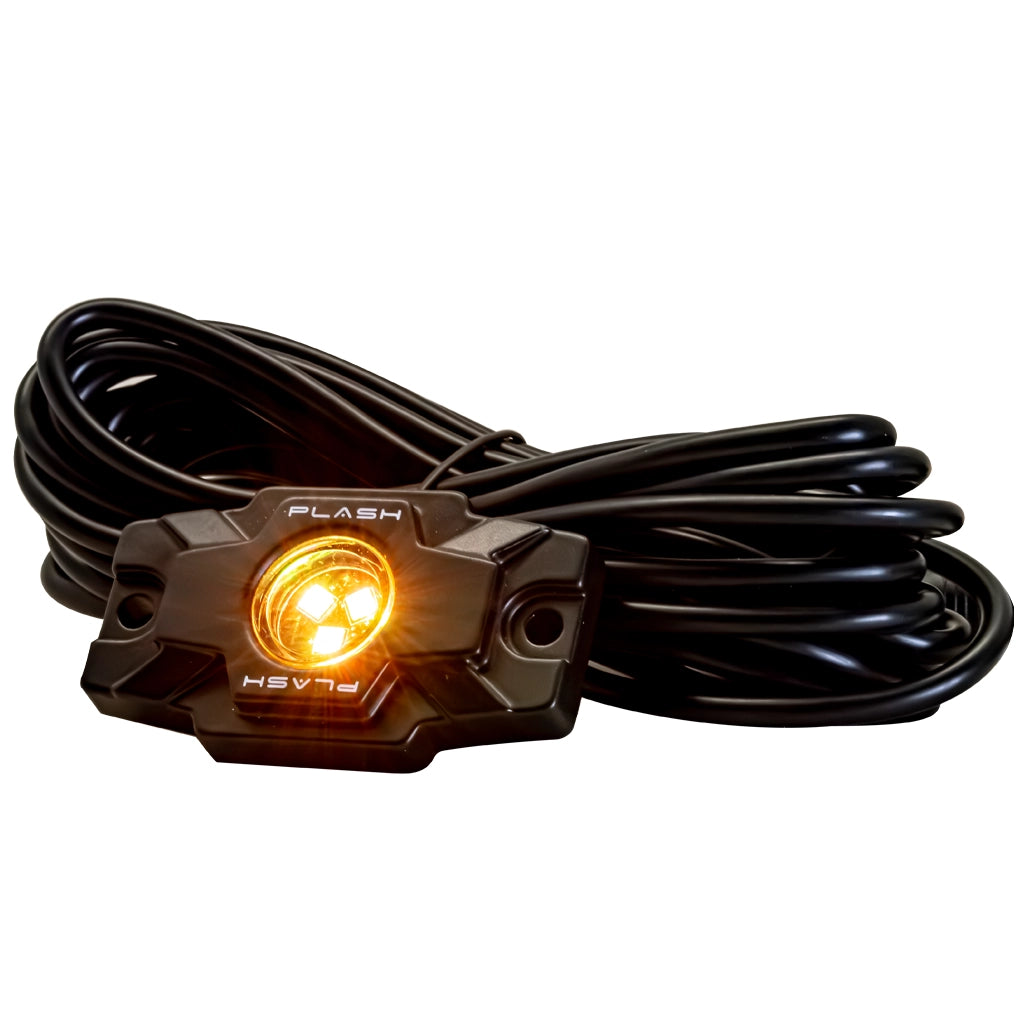 A black Plash Branded LED Rock light with a coiled black cable, shown with its amber LED lights illuminated, on a solid white background.